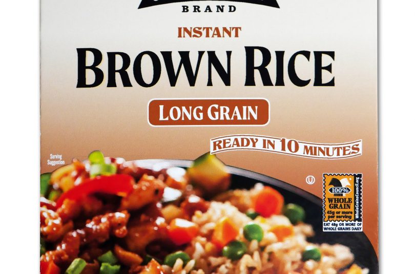 Brown package of Jack Rabbit Brand Instant Brown Rice. The box reads, "Gluten Free - Non-GMO - Precooked, Jack Rabbit Brand Instant Brown Rice, long grain, ready in 10 minutes." The box has an image of a brown rice dish with meat and vegetables.