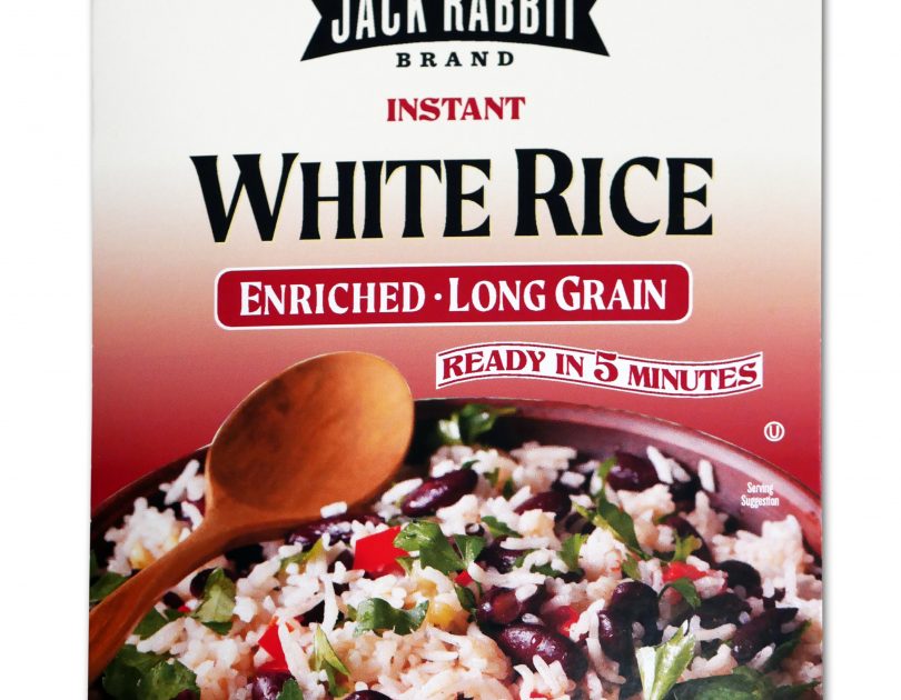 Red package of Jack Rabbit Brand Instant White Rice. The box reads, "Gluten Free - Non-GMO - Precooked, Jack Rabbit Brand Instant White Rice, enriched - long grain, ready in 5 minutes." The box has an image of a white rice dish with black beans and vegetables.